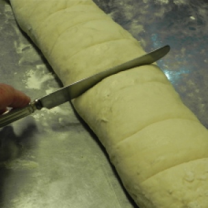 Use a knife to make cut marks for equally-portioned buns